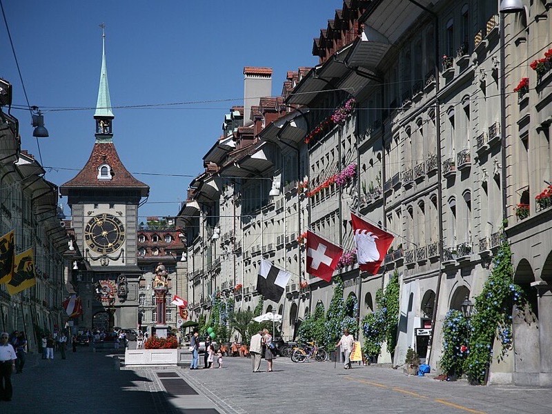 Cobblestoned old town lane with medieval guild houses and an arched passage in Bern